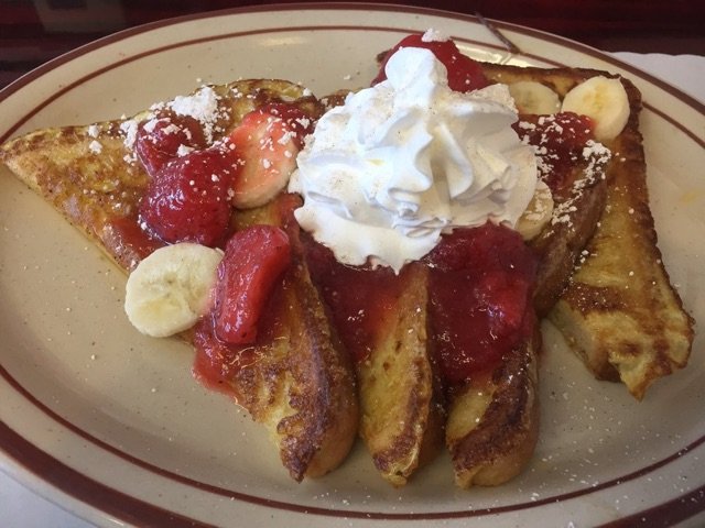 Strawberry Banana French Toast Dusted with Powdered Sugar at Centinela Cafe